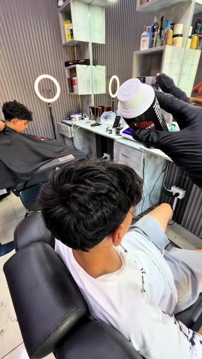 A low taper haircut, tightly faded at the sides