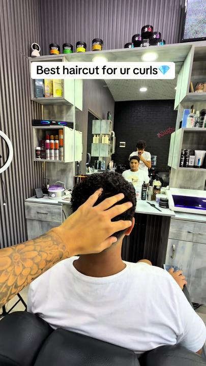 Curly hair, cut short on the sides